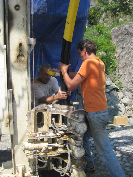 Pushing the pipes into the drilling hole